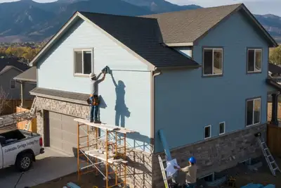 Technicians installing vinyl siding on Colorado Springs CO home for professional exterior upgrade