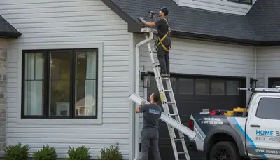 Technician repairing gutters on vinyl-sided home in Colorado Springs, CO